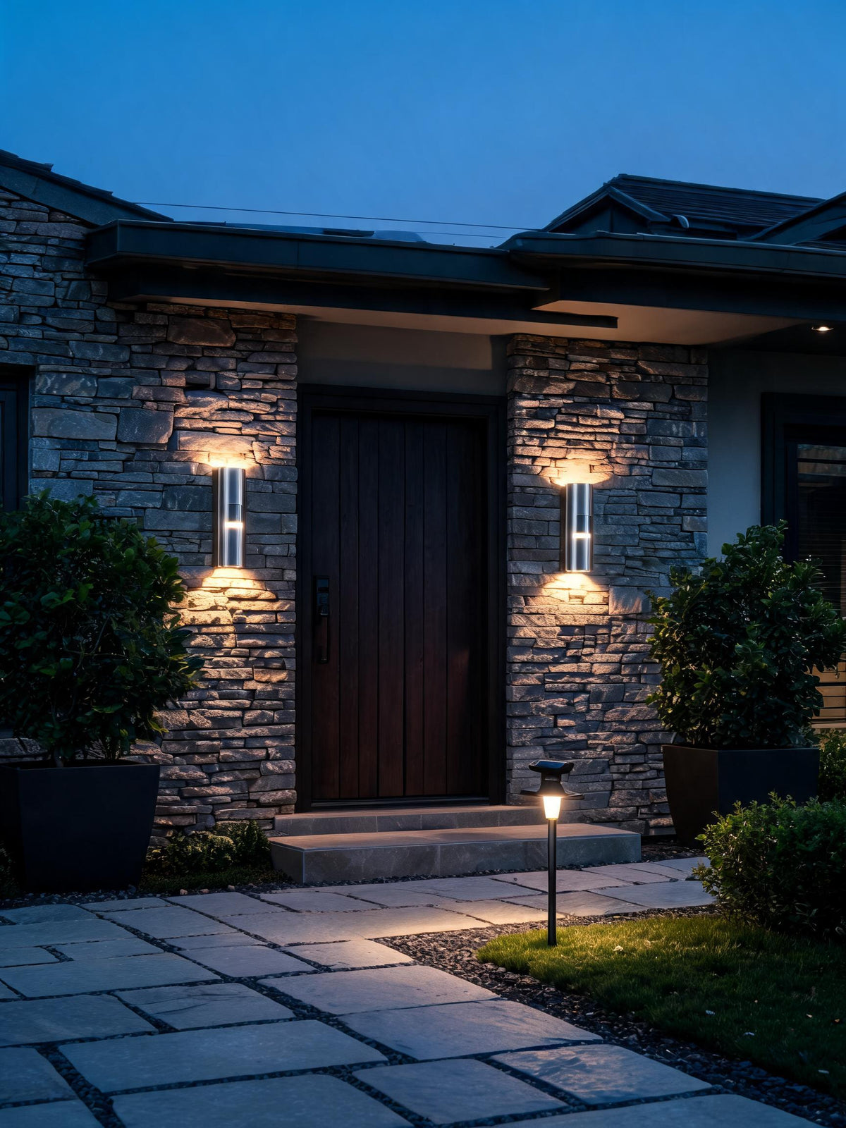 Modern porch with glowing outdoor wall lights at dusk