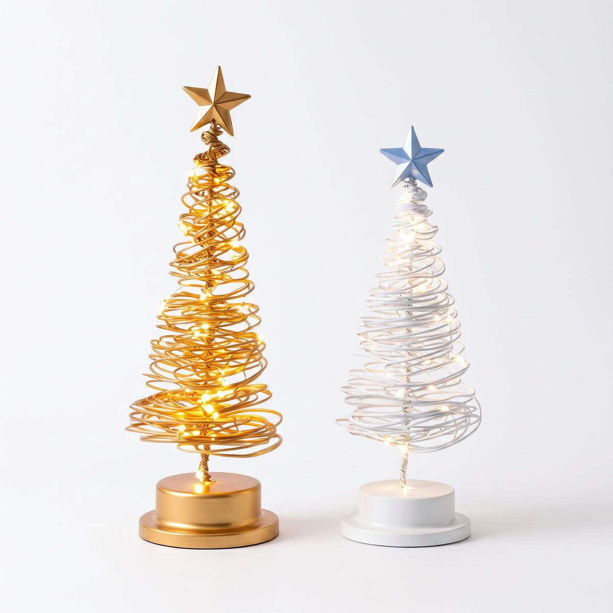 Gold and white wire LED Christmas trees on white background